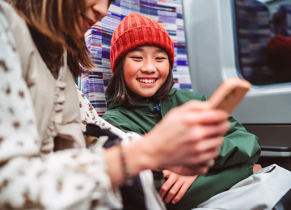 Children on their phone on a train