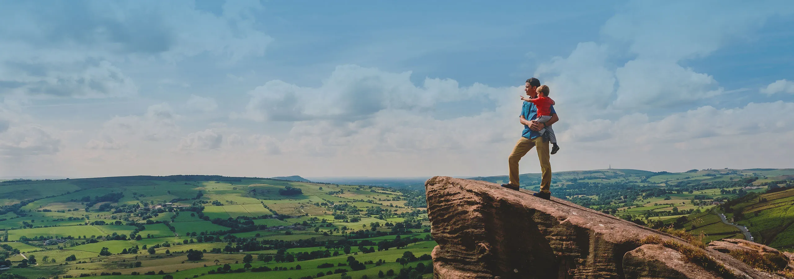 A man on top of a large rock