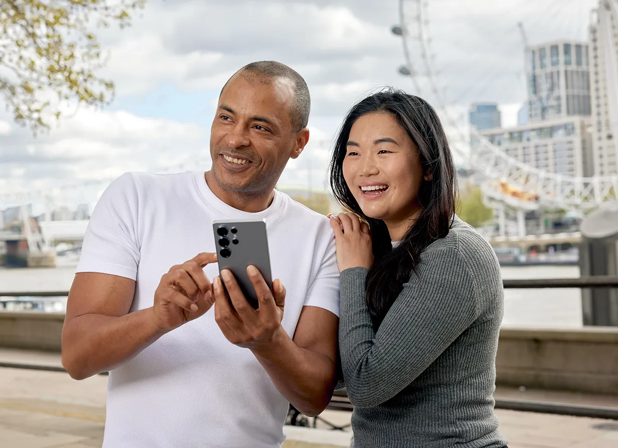 A couple in London looking at a phone