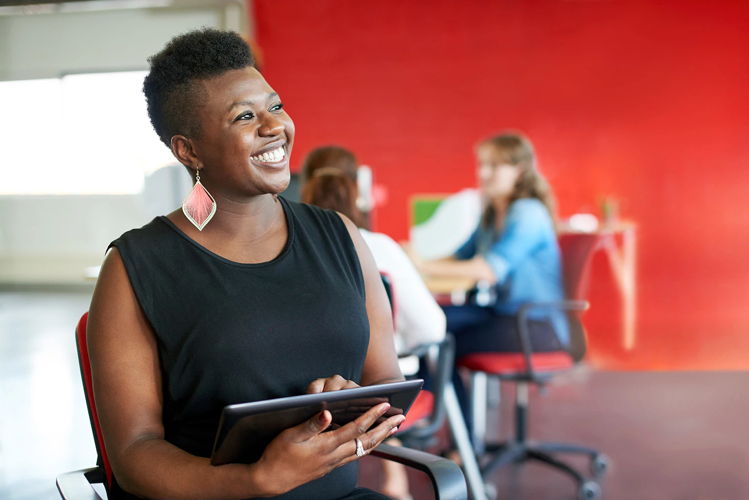 Smiling Woman holding a tablet