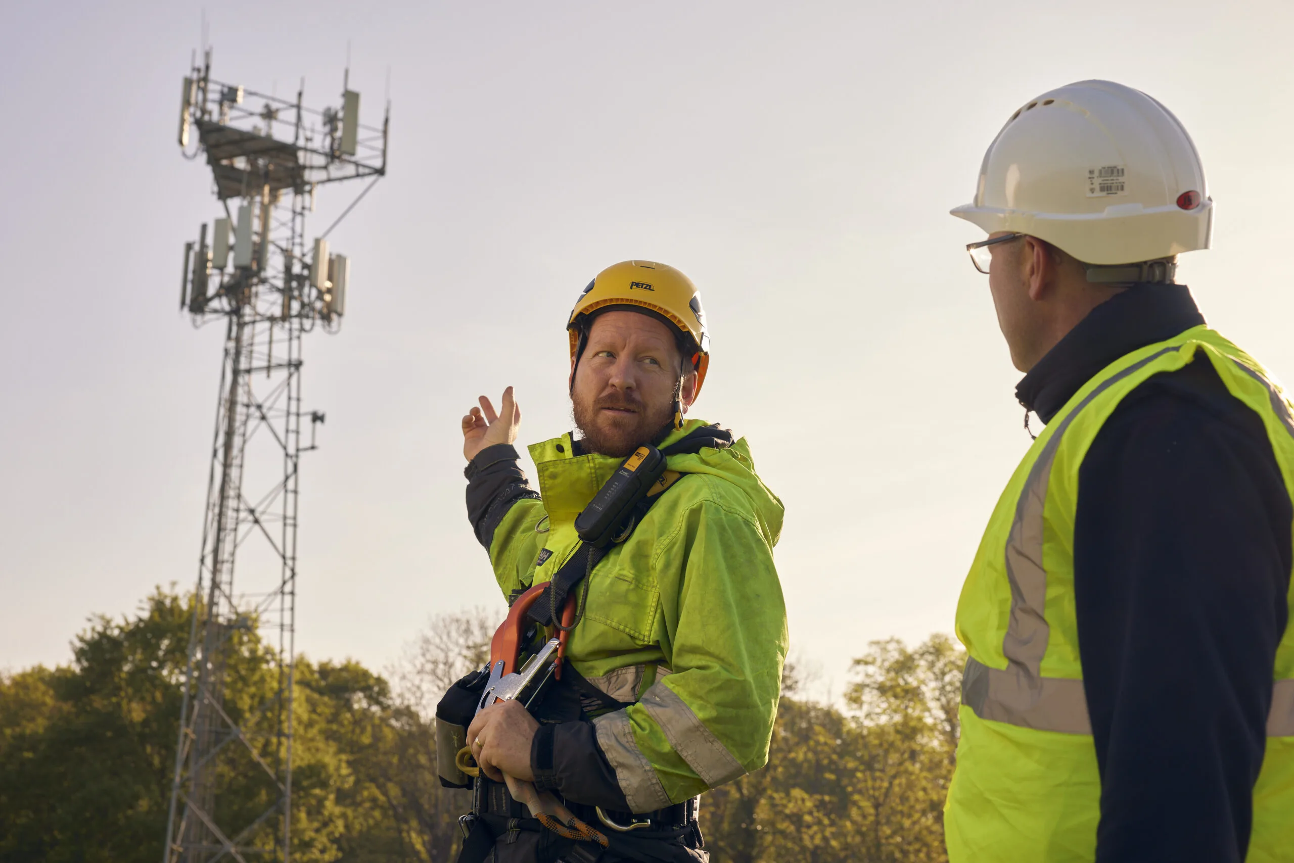 Network engineers pointing at mast.