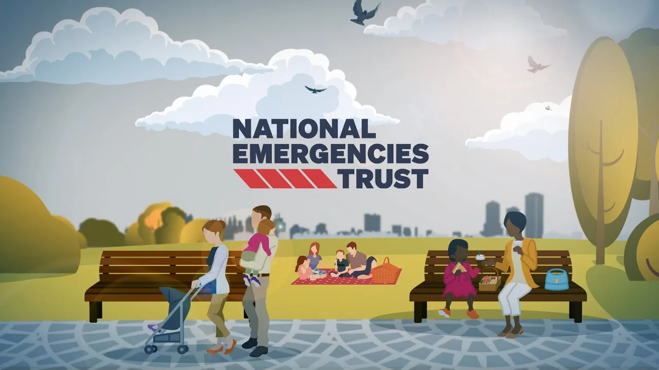 Cartoon illustration of people in a park with the text 'NATIONAL EMERGENCIES TRUST'. A woman pushes a stroller, a man carries a child, a family picnics, and a woman and girl sit on a bench. City skyline and trees are in the background.