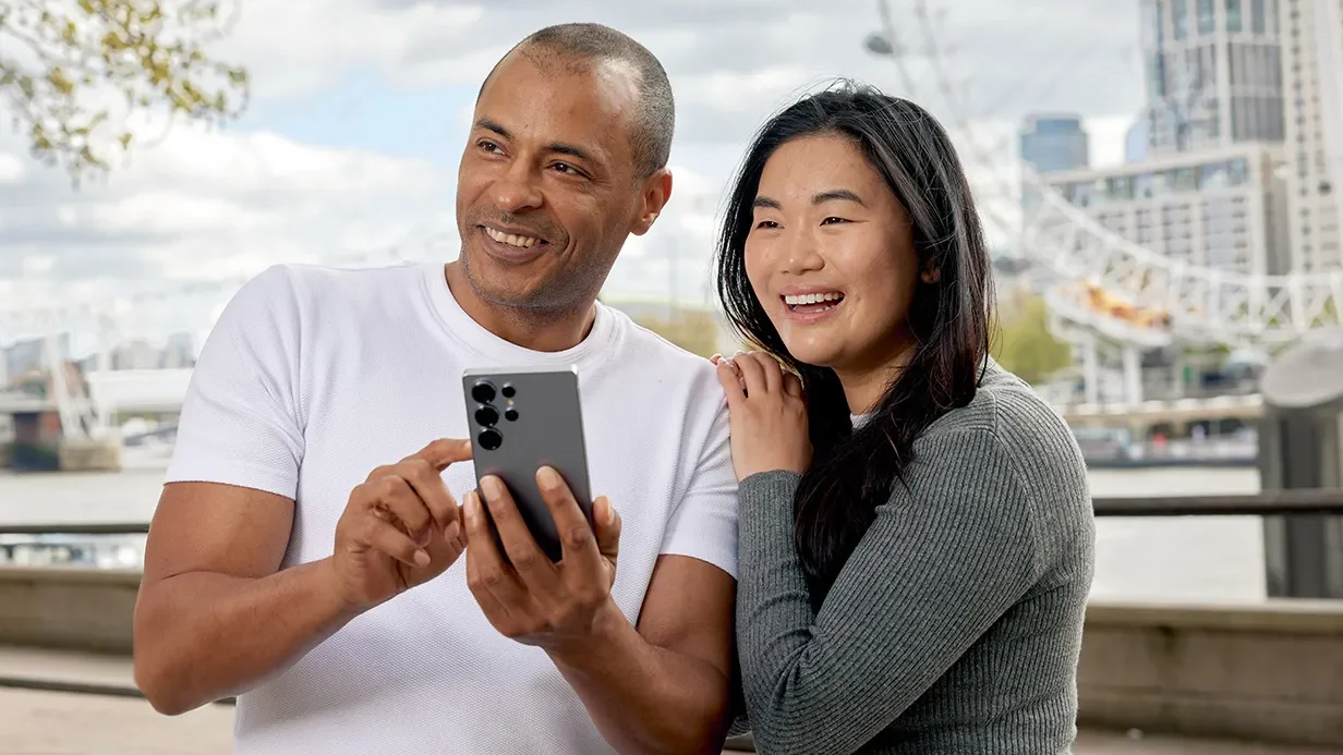 A couple in London looking at a phone